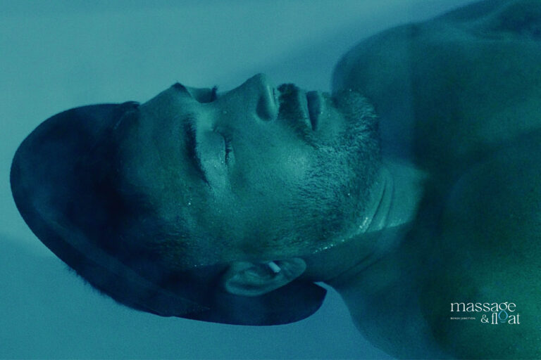 Man relaxing with eyes closed in a float therapy tank