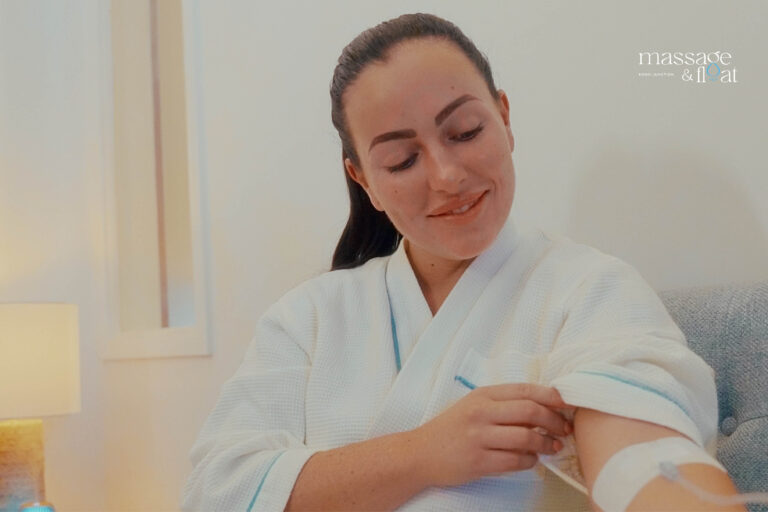 Woman sitting on couch with IV Drip of nutrients.